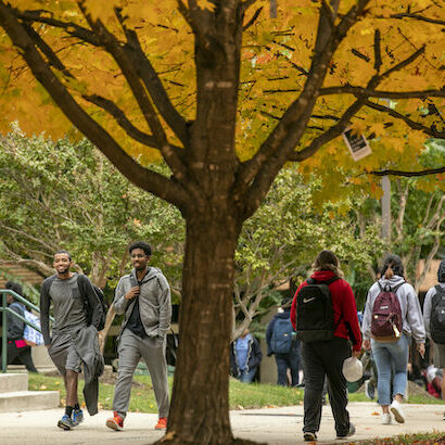 Students walking the Fairfax Campus with fall colors. Photo by:  Ron Aira/Creative Services/George Mason University